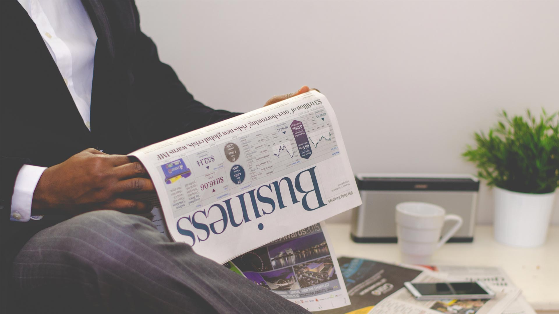Reading business section of newspaper