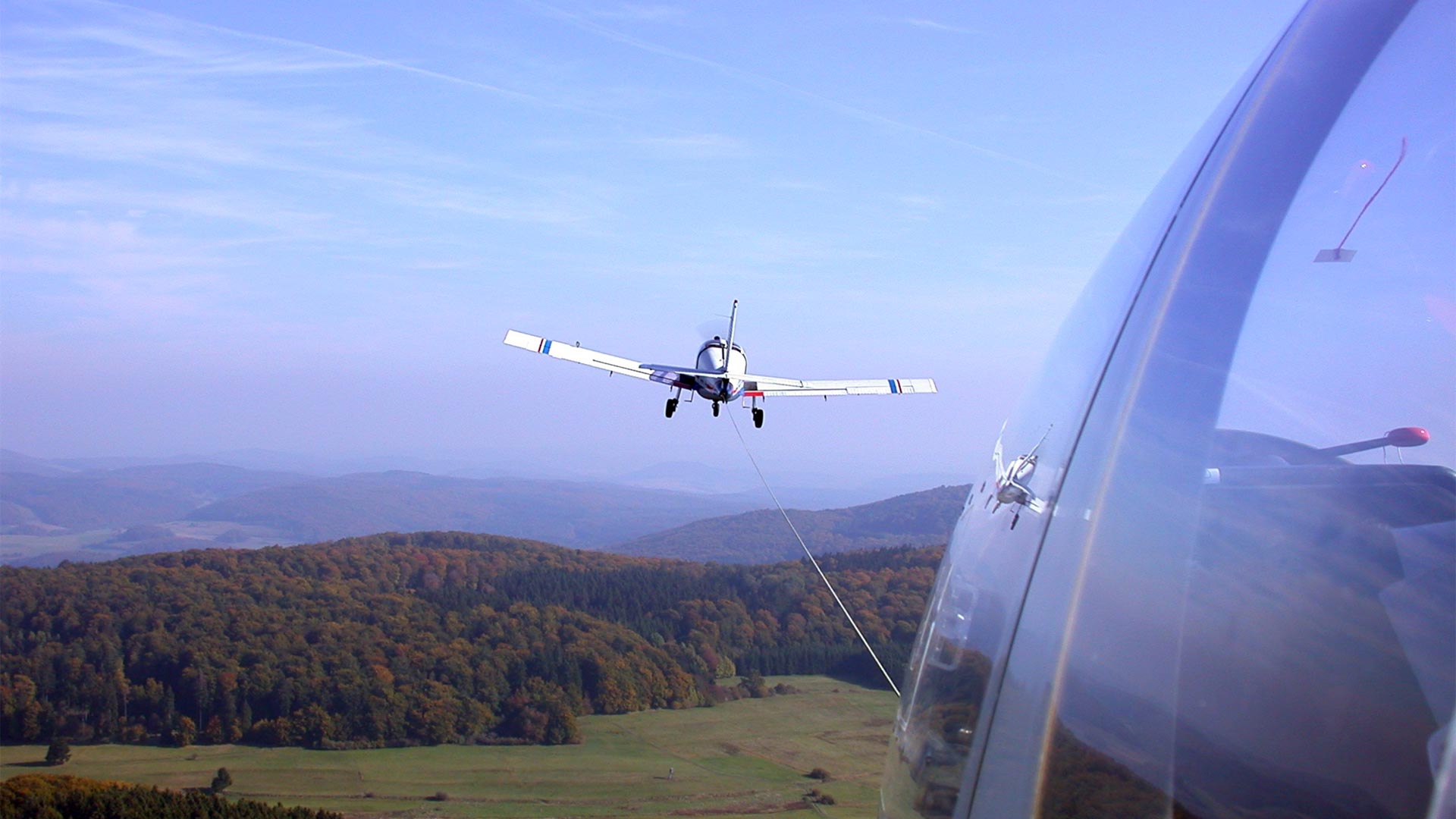 airplane being pulled by another airplane