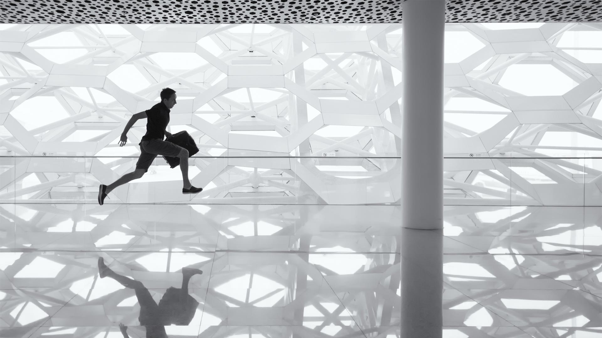 Man running in office building with briefcase