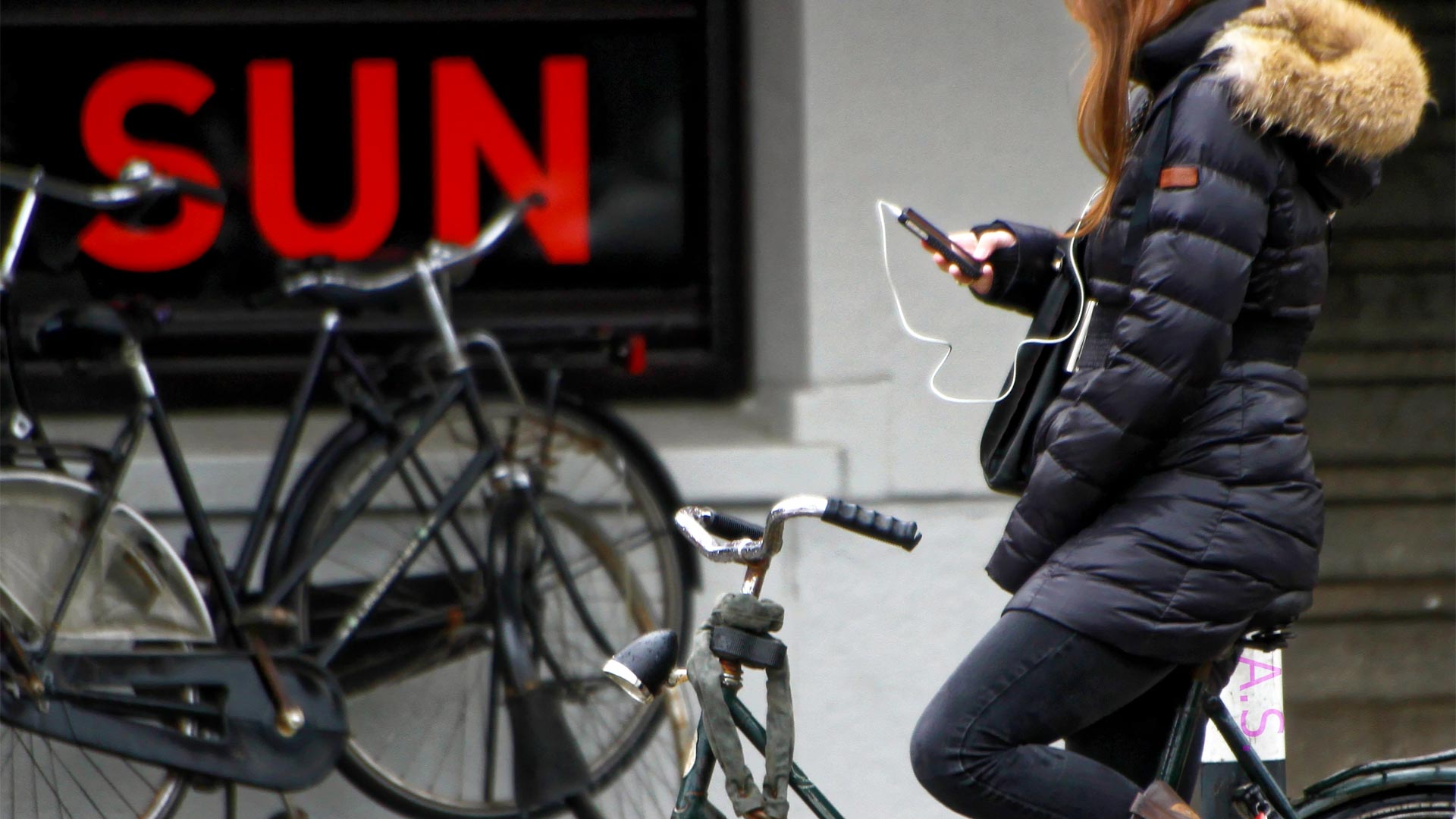 girl using cell phone on bike