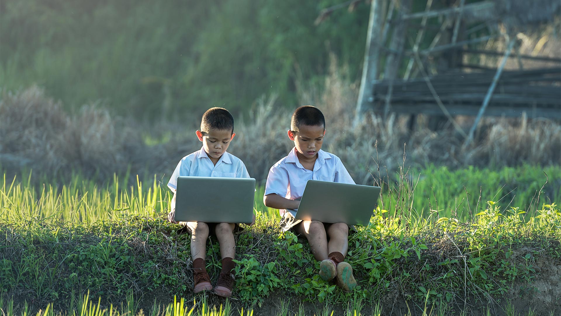 Two kids on laptops
