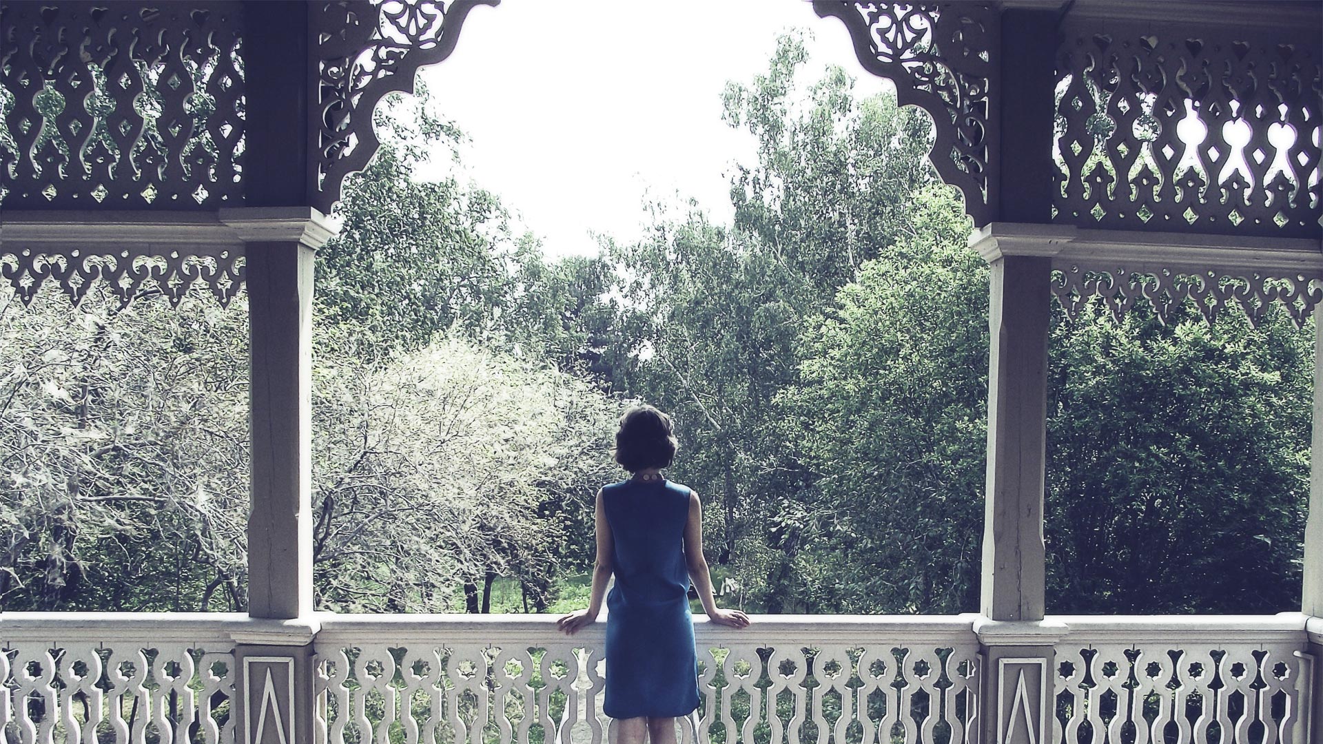 Woman looking over a balcony