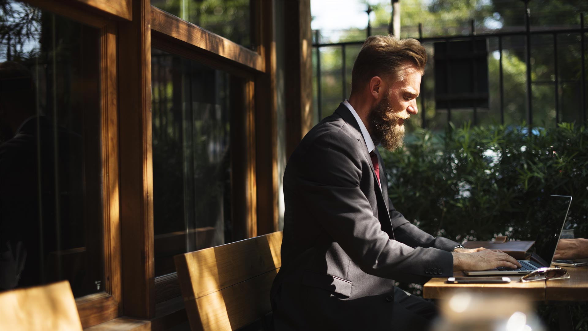Bearded man in suit working