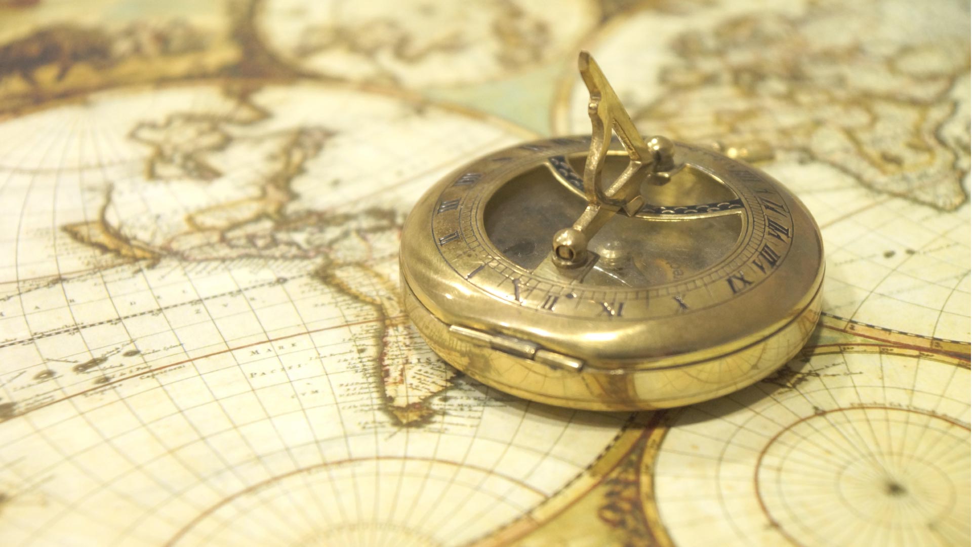 Gold compass on map