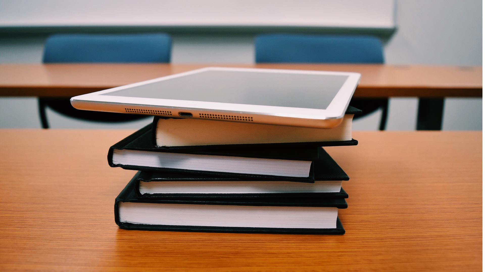 iPad on book pile