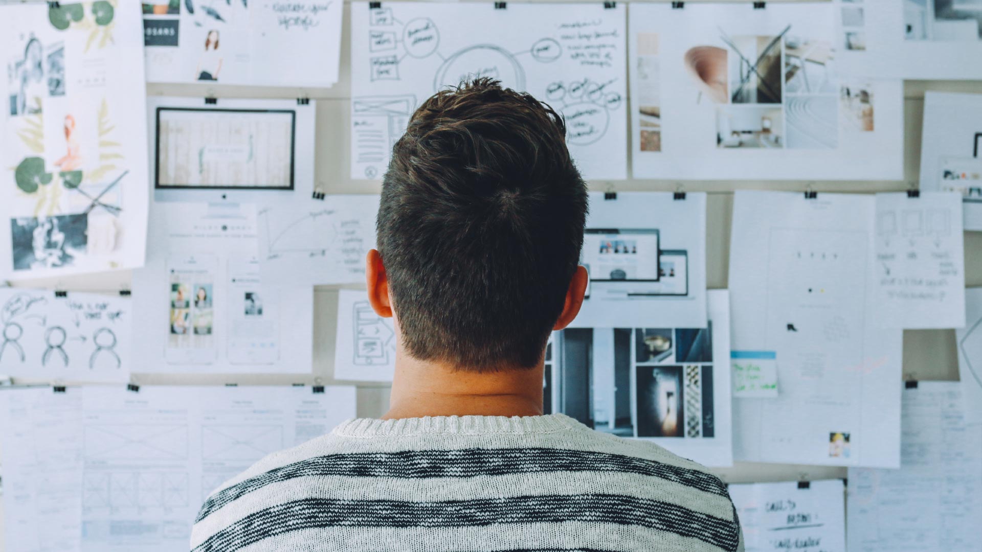 Man looking at inspiration wall
