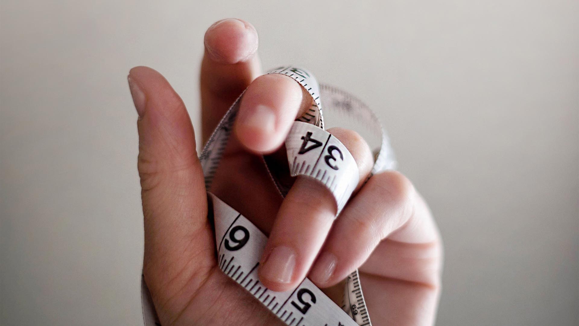 Tape measure wrapped around fingers