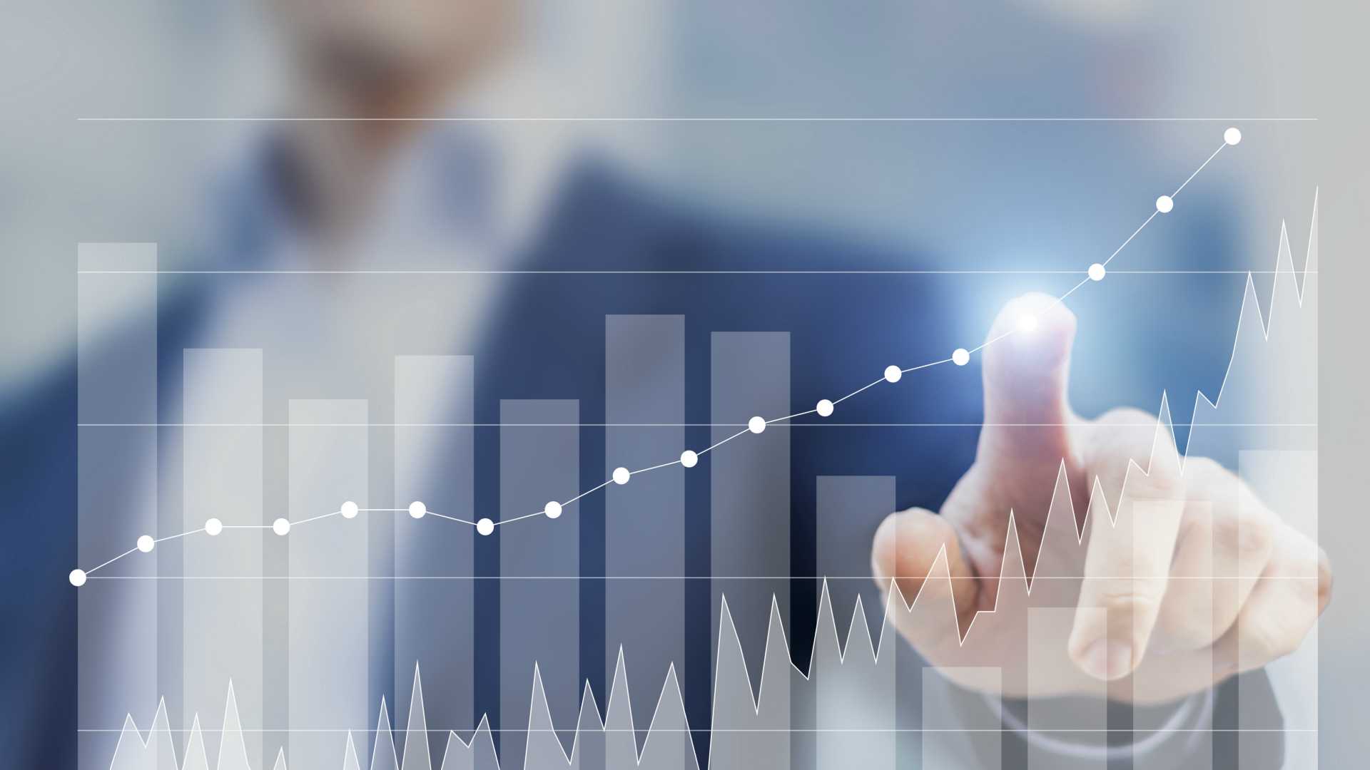 Expert businessman using business intelligence to sketch future growth and success with charts