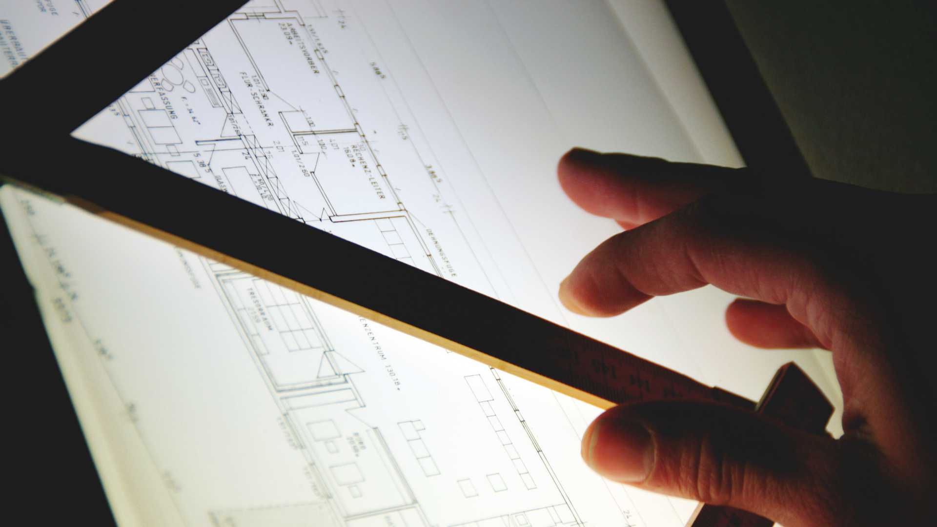 pen over a lit blueprint