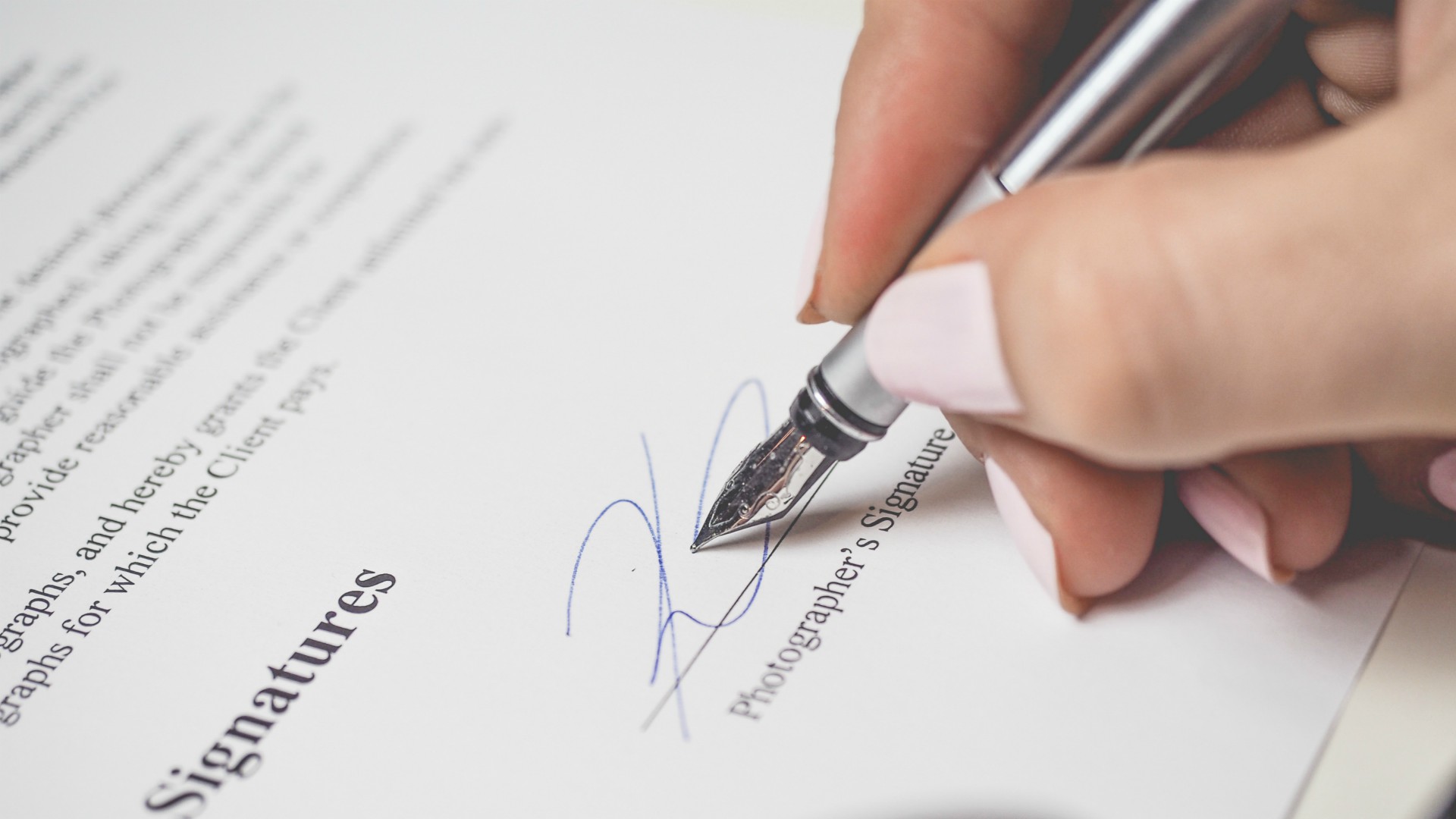 woman signing a contract