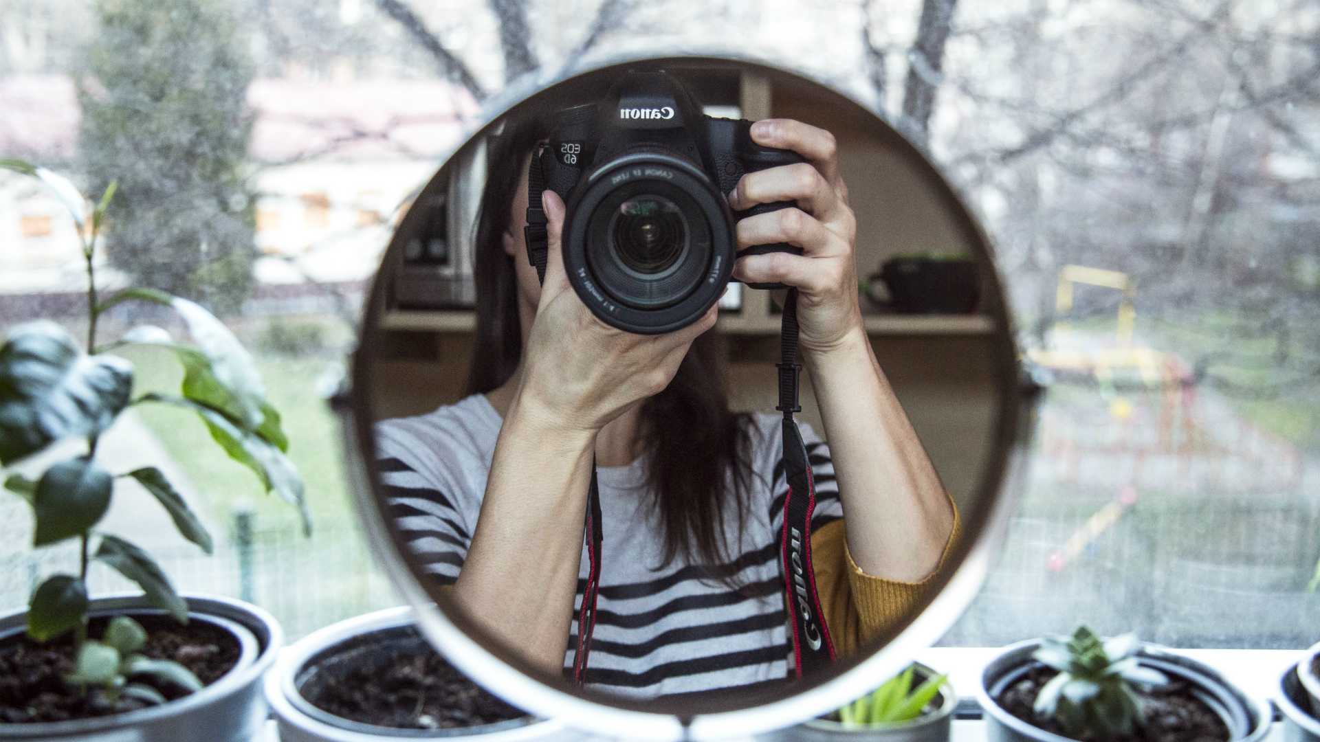 woman taking a picture in a mirror