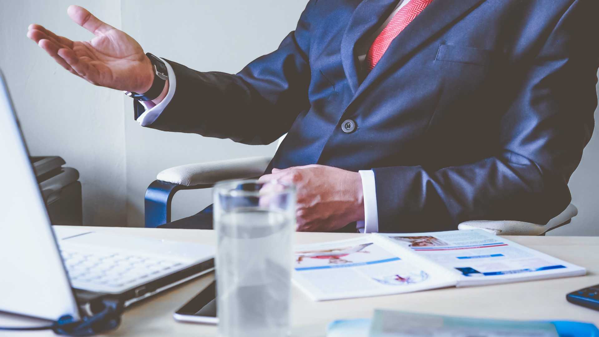 businessperson at a desk, talking