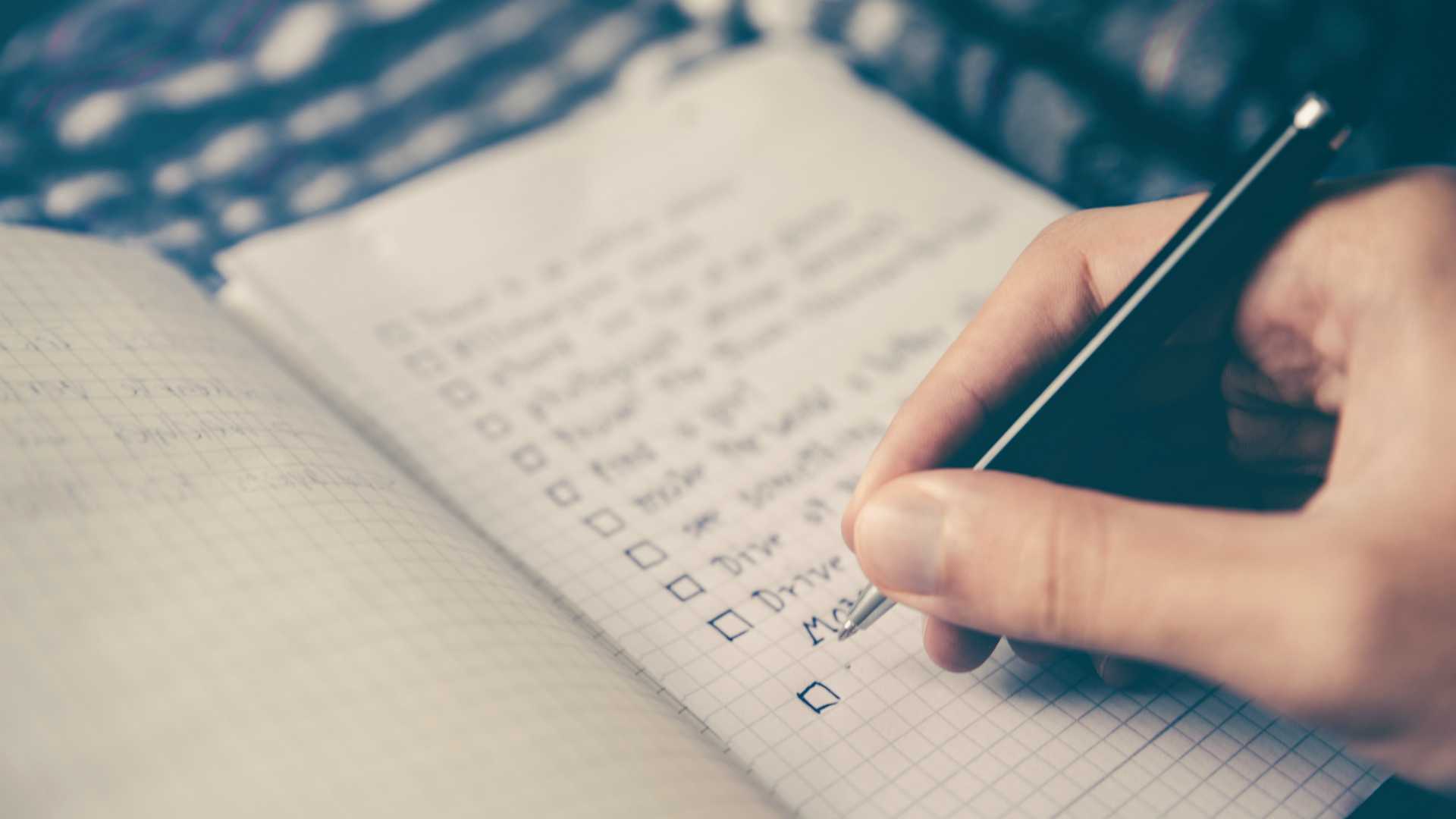 hand writing a checklist