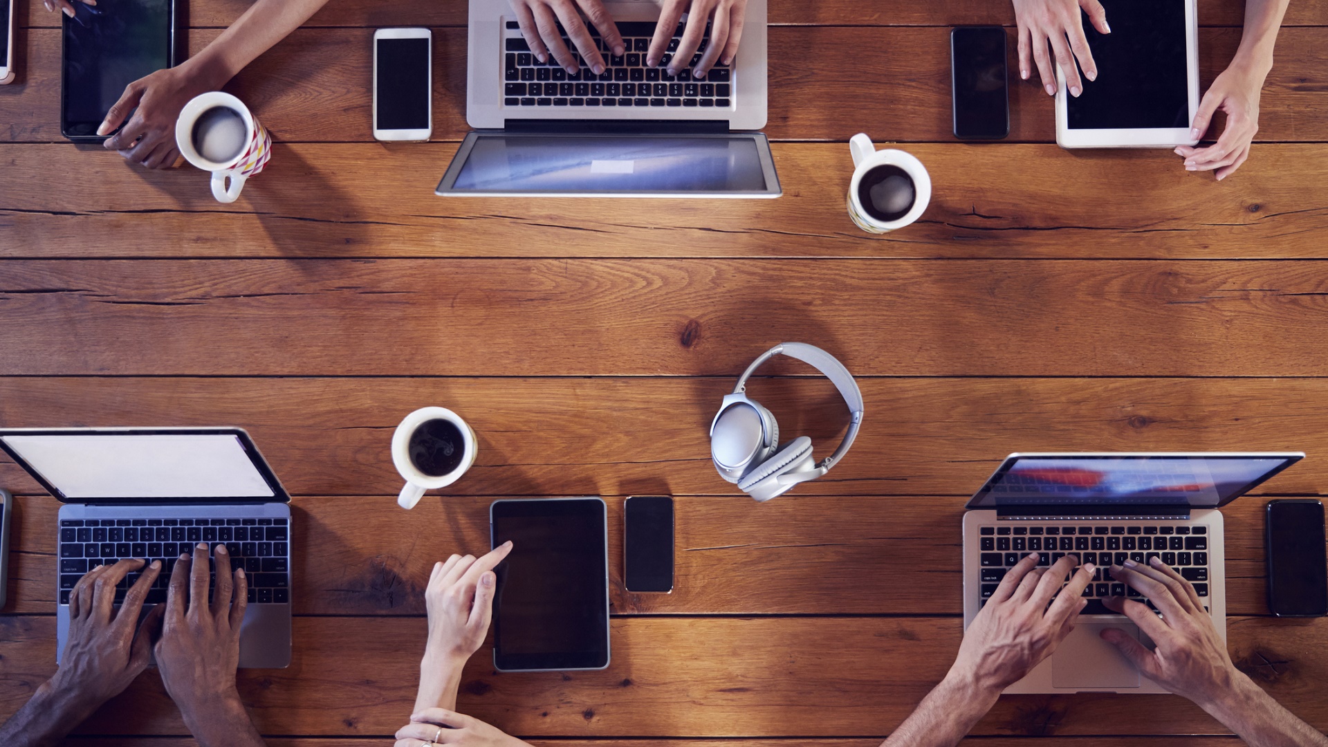 young employees with laptops and phones