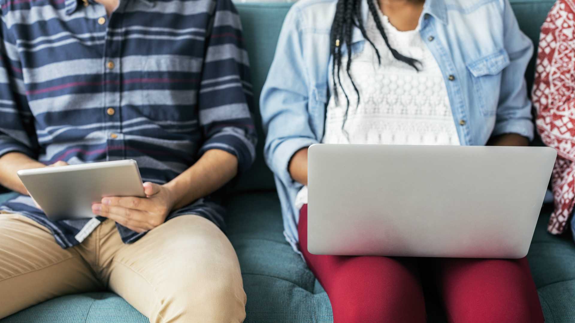 young people working on a laptop and a tablet