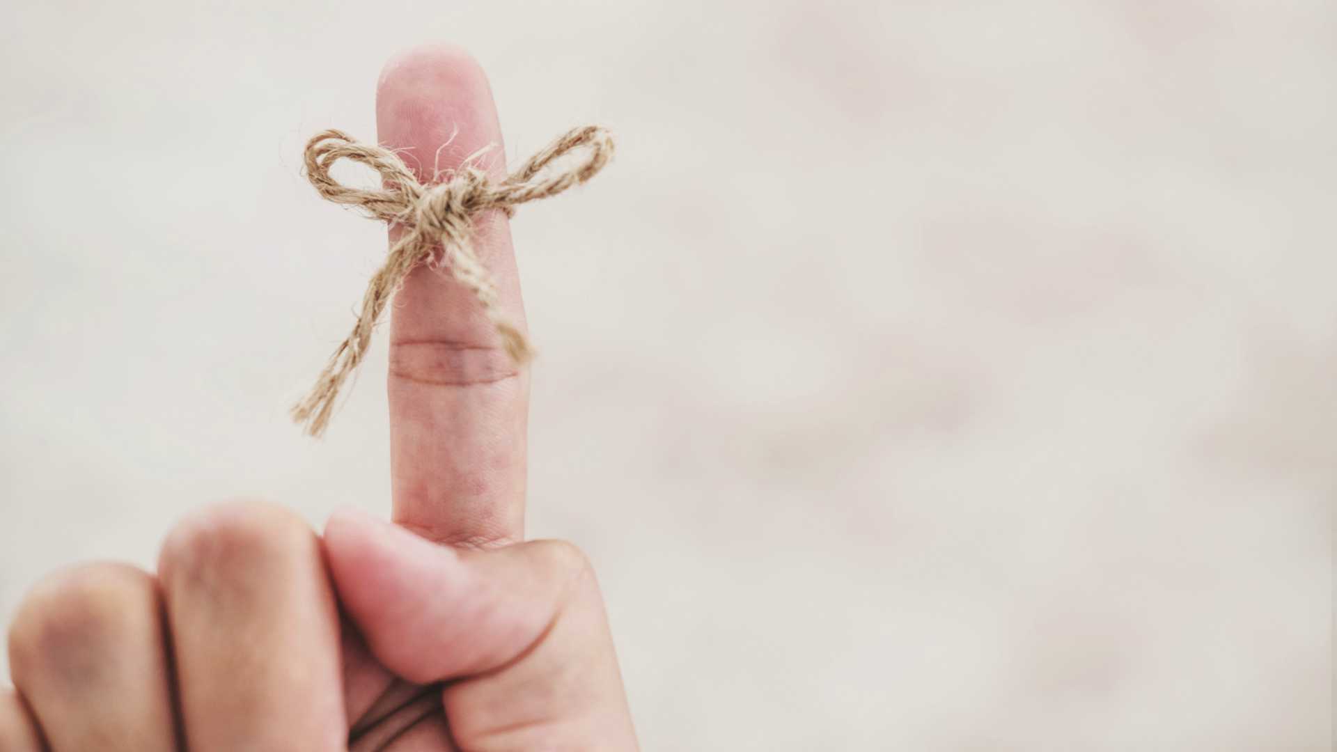 pointing finger with knot tied around it