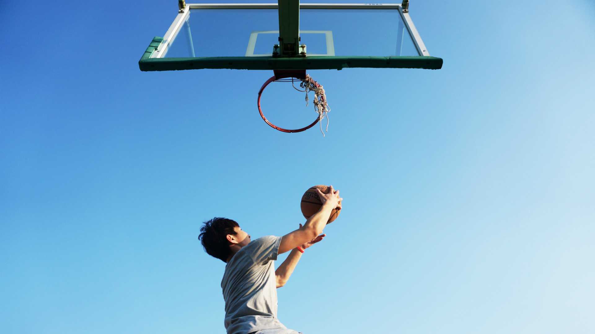 person shooting a basket