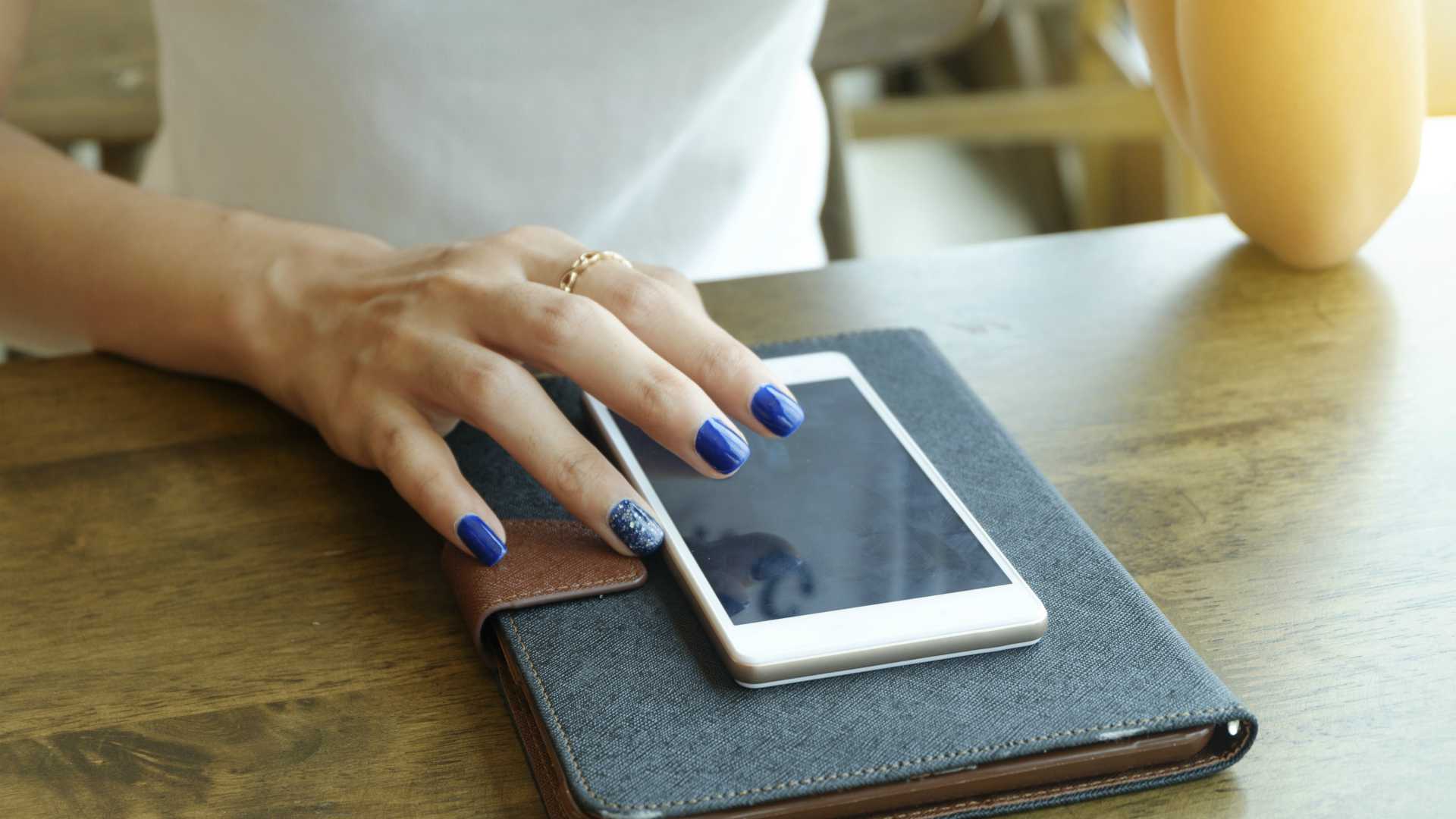 woman with a mobile phone and notebook