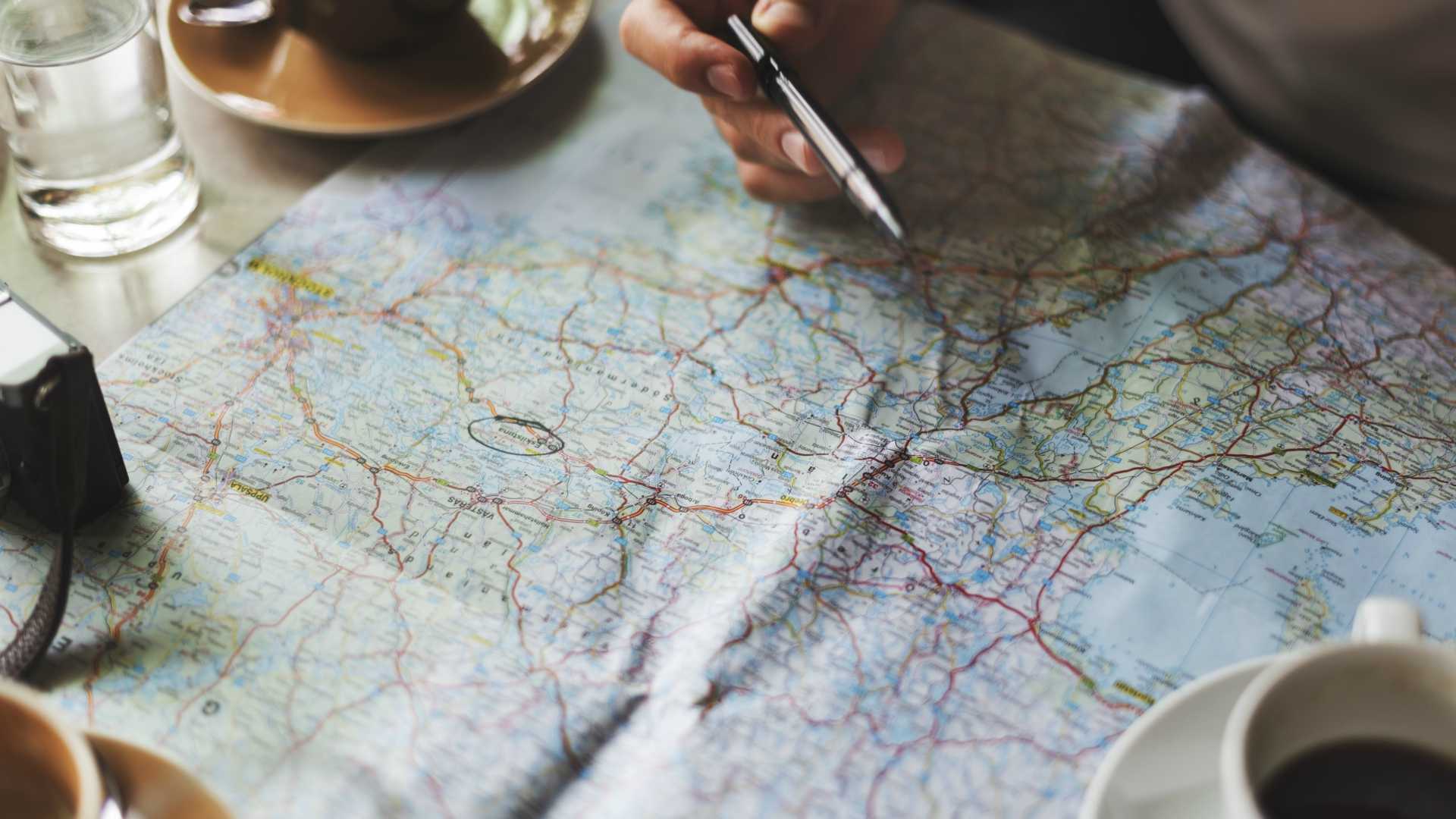 person writing on a map