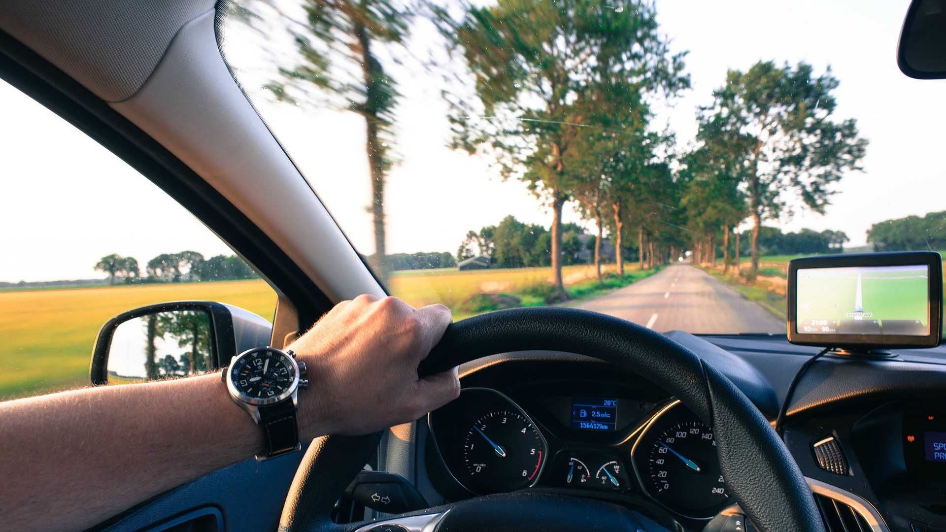 man driving a car with a GPS