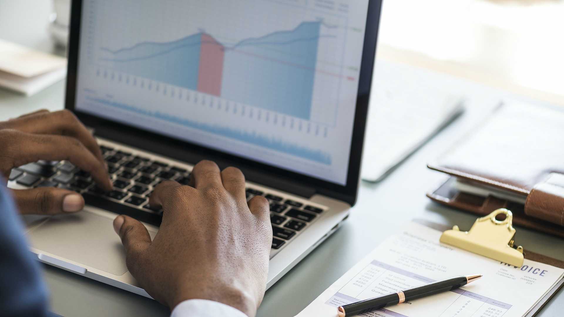 laptop with charts and checklist