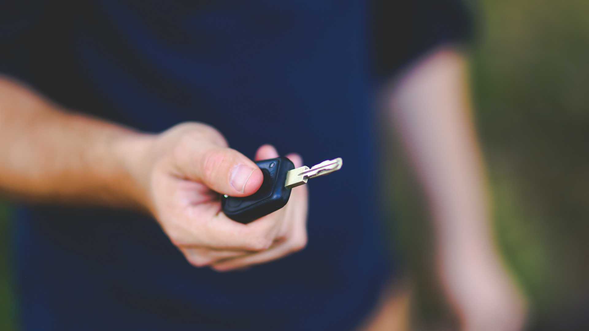 person handing someone a key