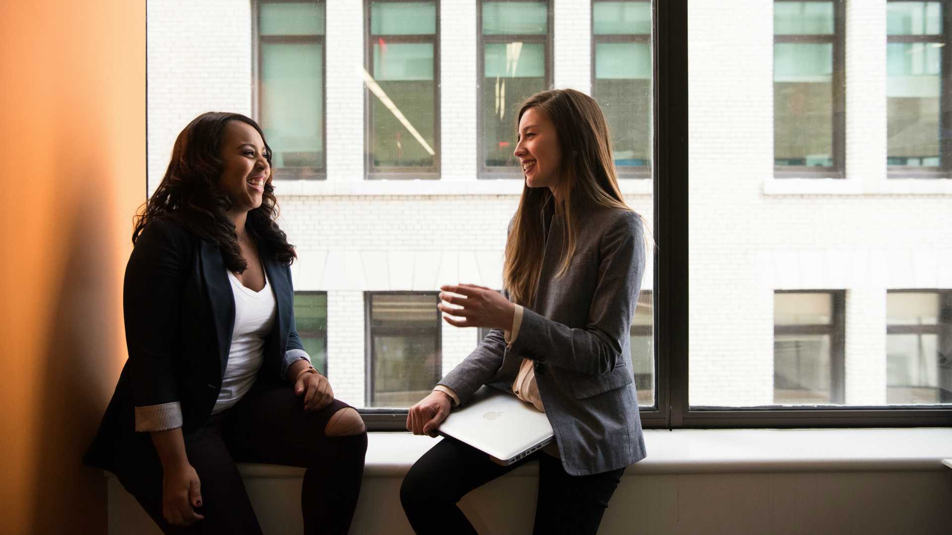 two women talking in an office