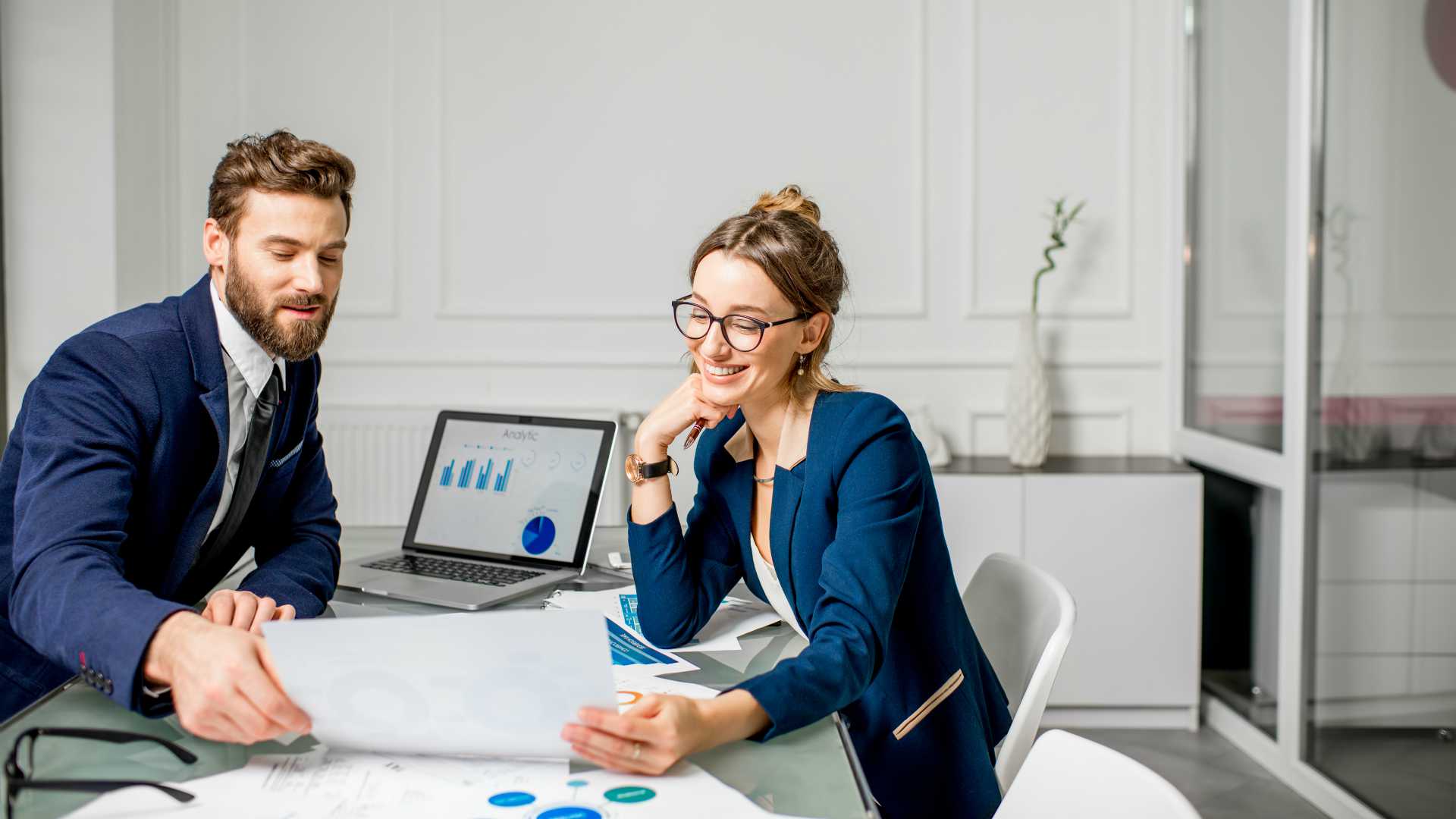 two professionals looking at analytics