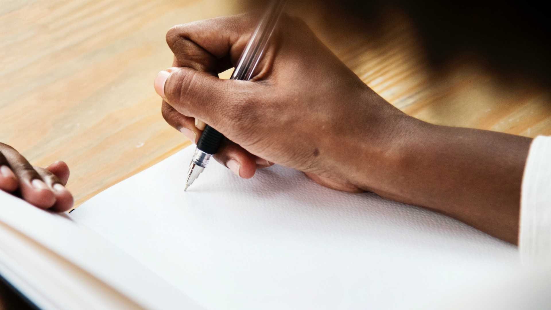 person writing in a notebook