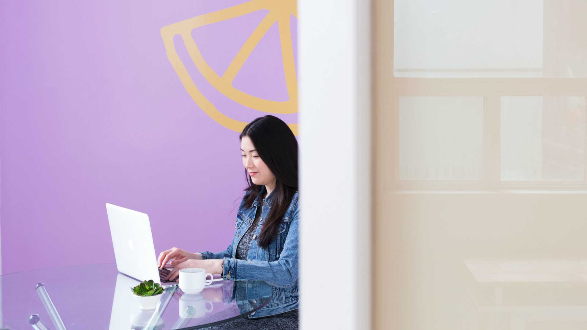 woman working on a laptop in a modern office