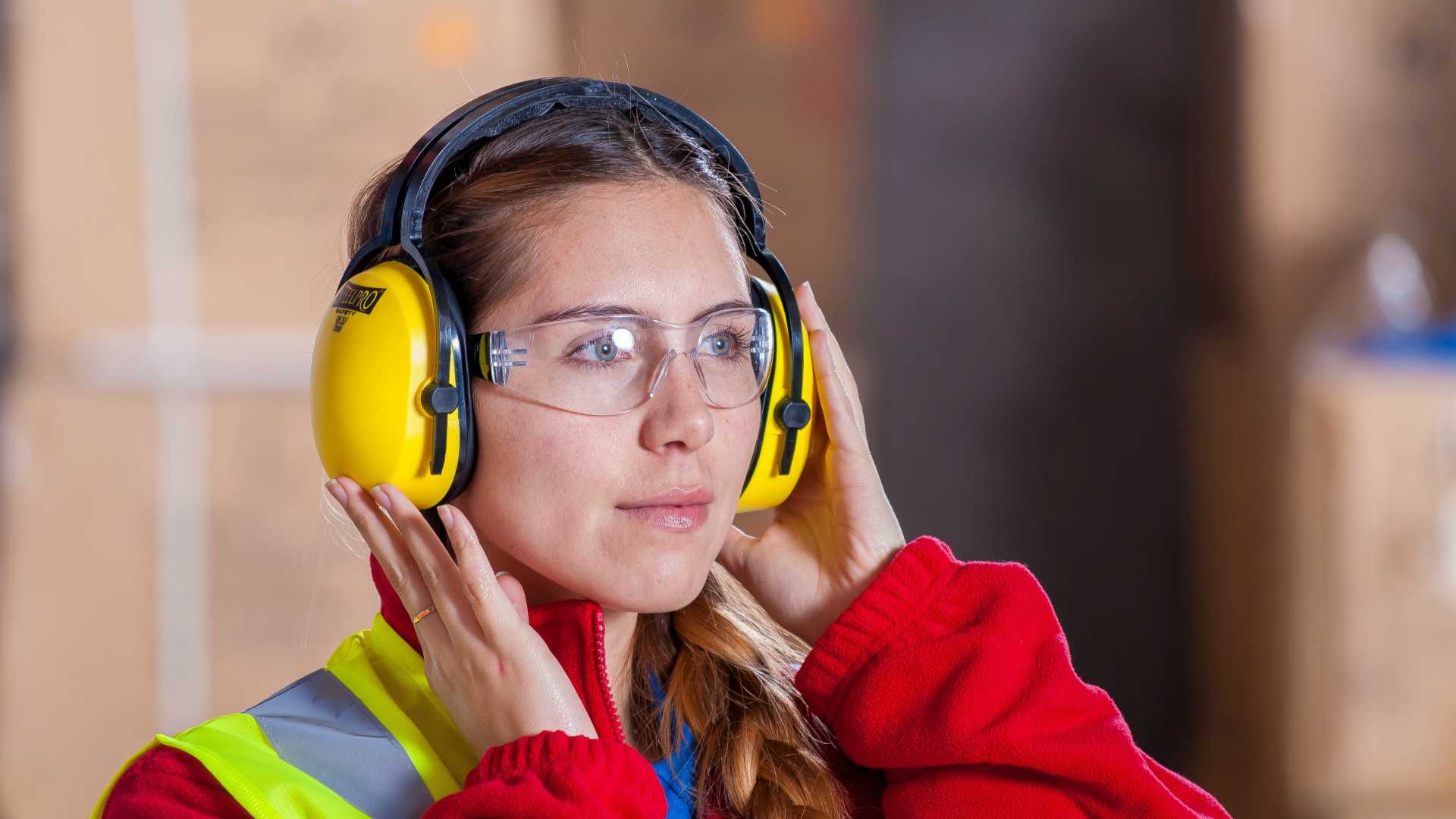 woman wearing safety goggles and ear protection