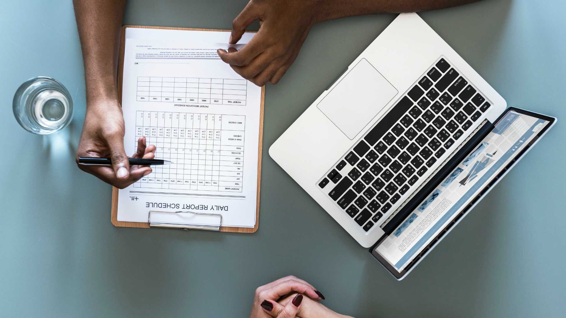 meeting with a laptop and a checklist