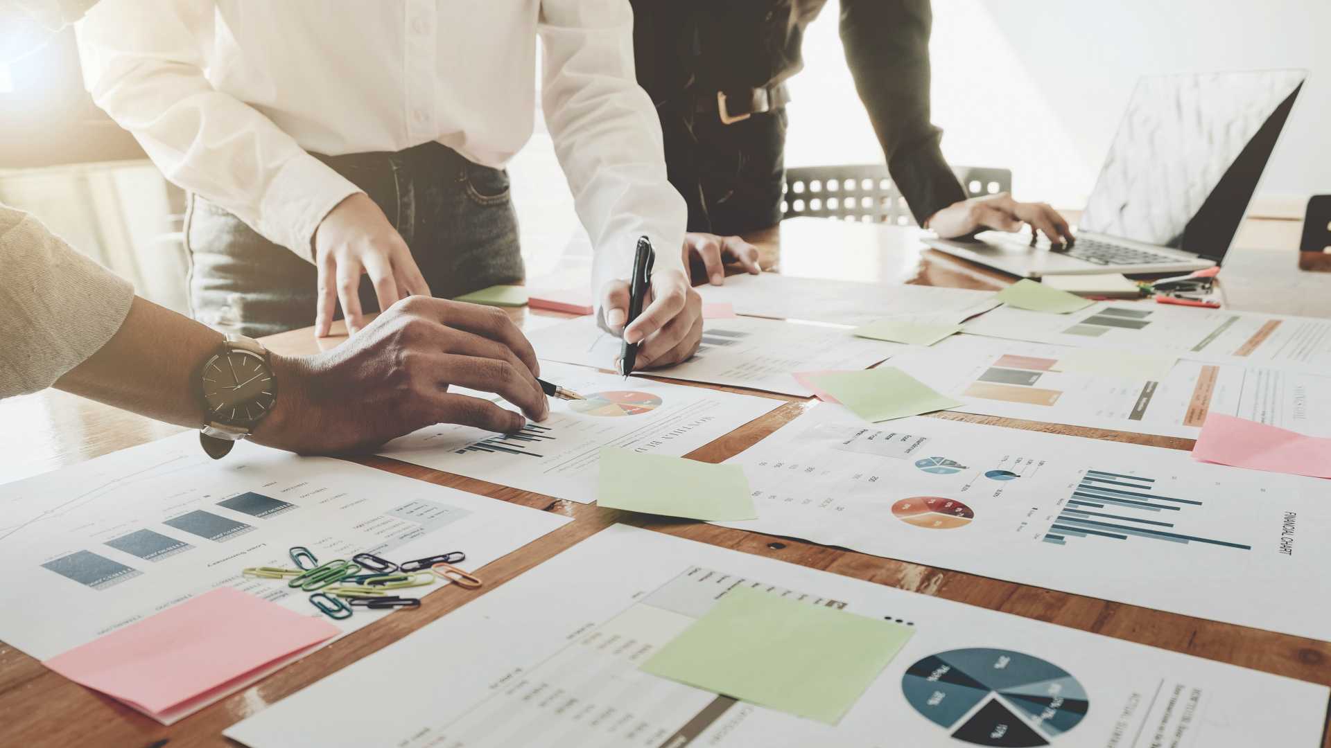 businesspeople looking at charts and data