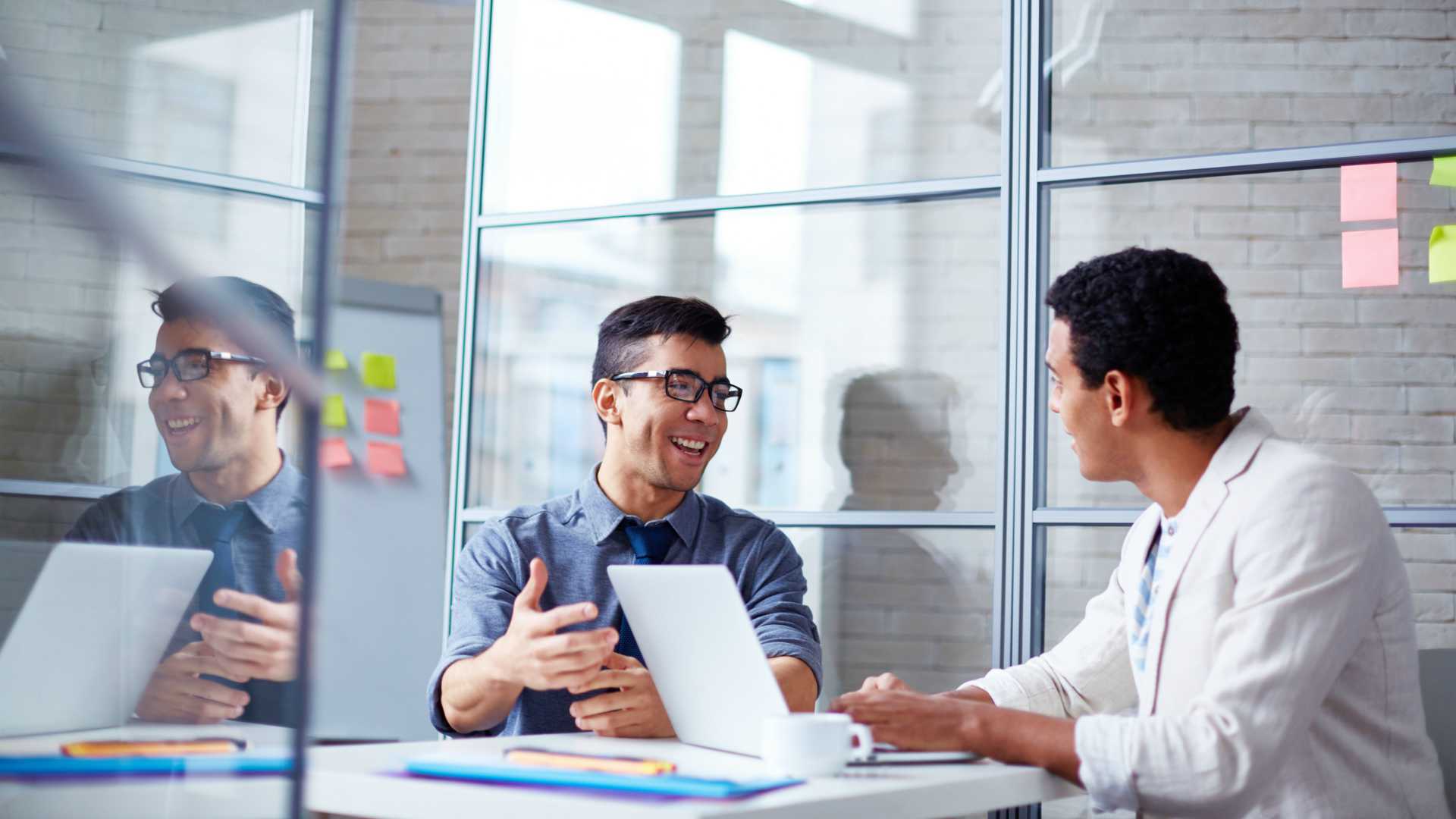 Two employees discussing data using a laptop