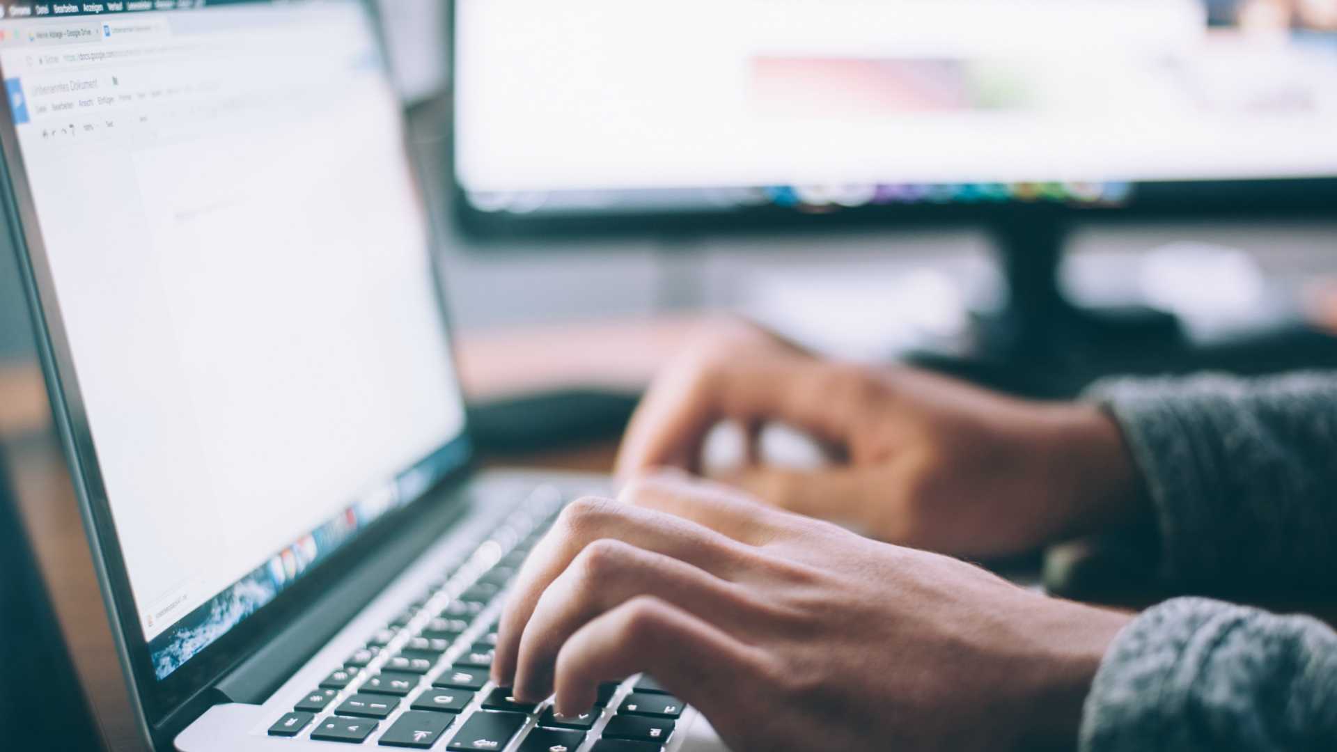 person typing on a laptop