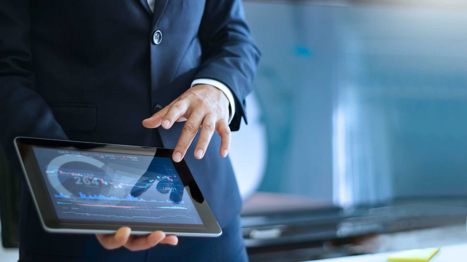 businessman showing charts on a tablet