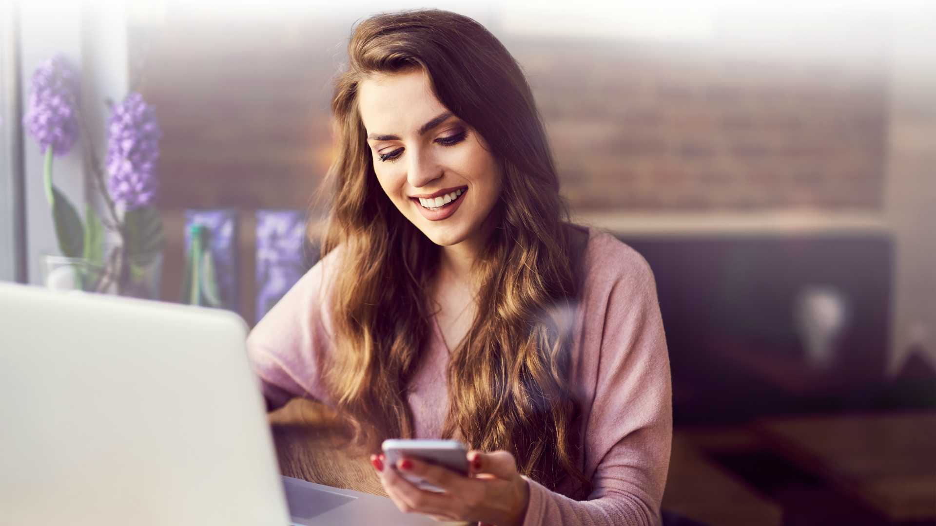 woman at work with a laptop and smartphone