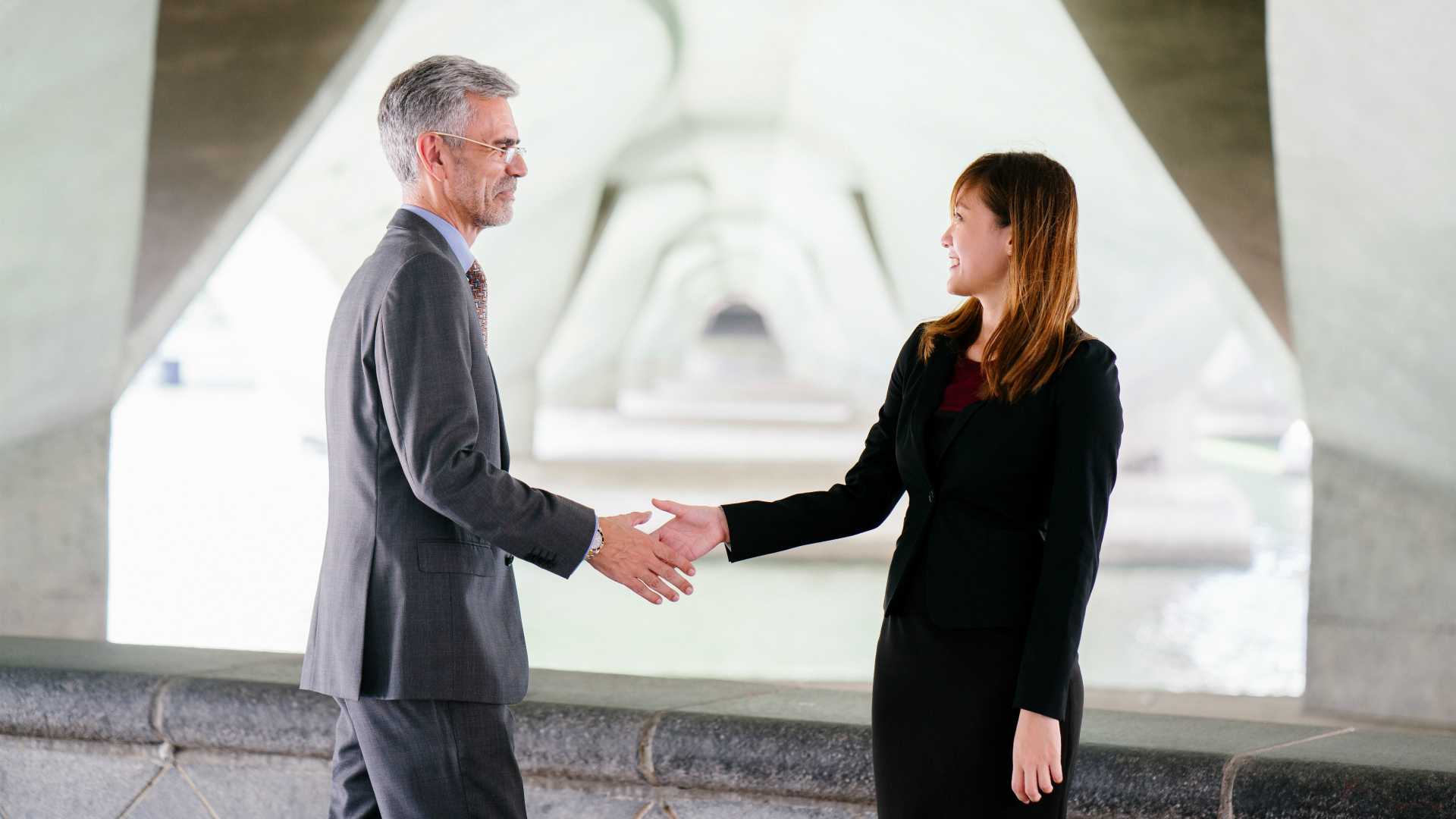 businessman and businesswoman shaking hands