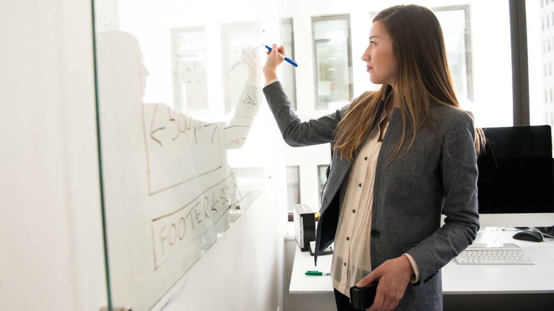 businesswoman writing on a whiteboard