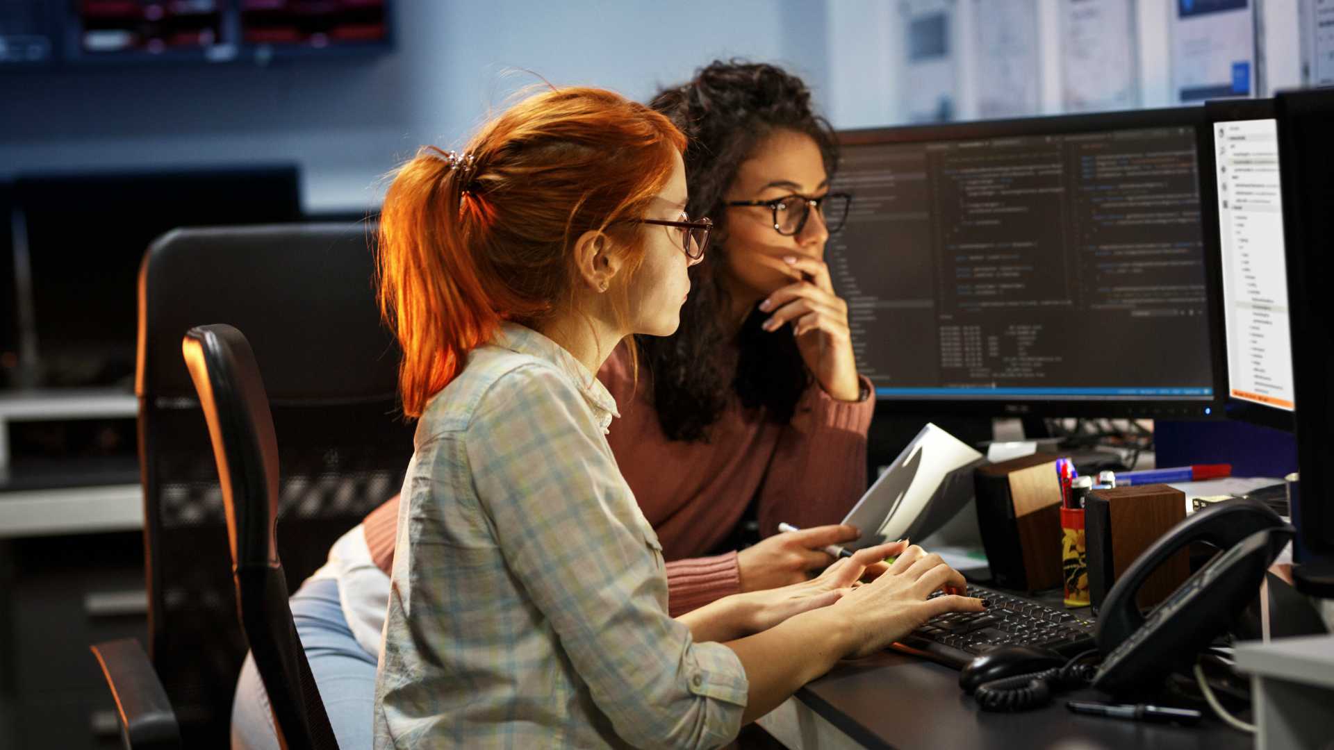two women working on code