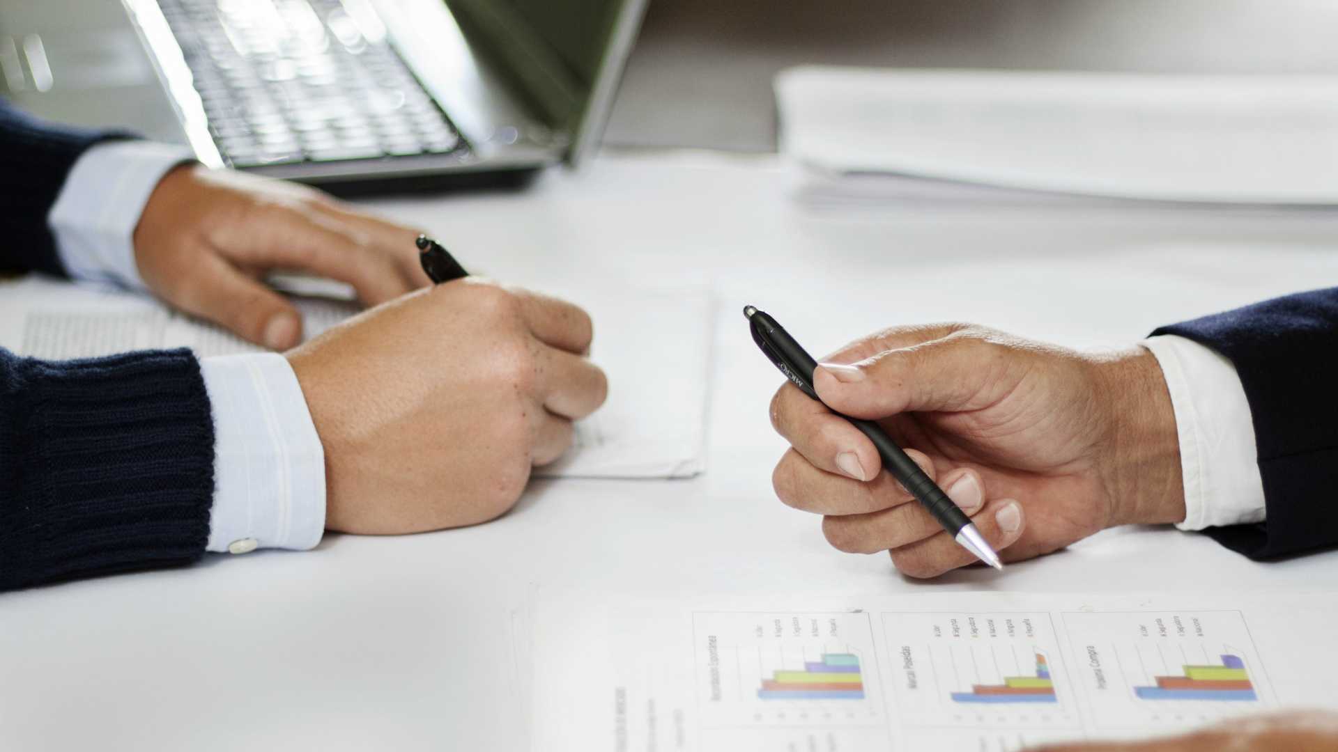 two people working on charts