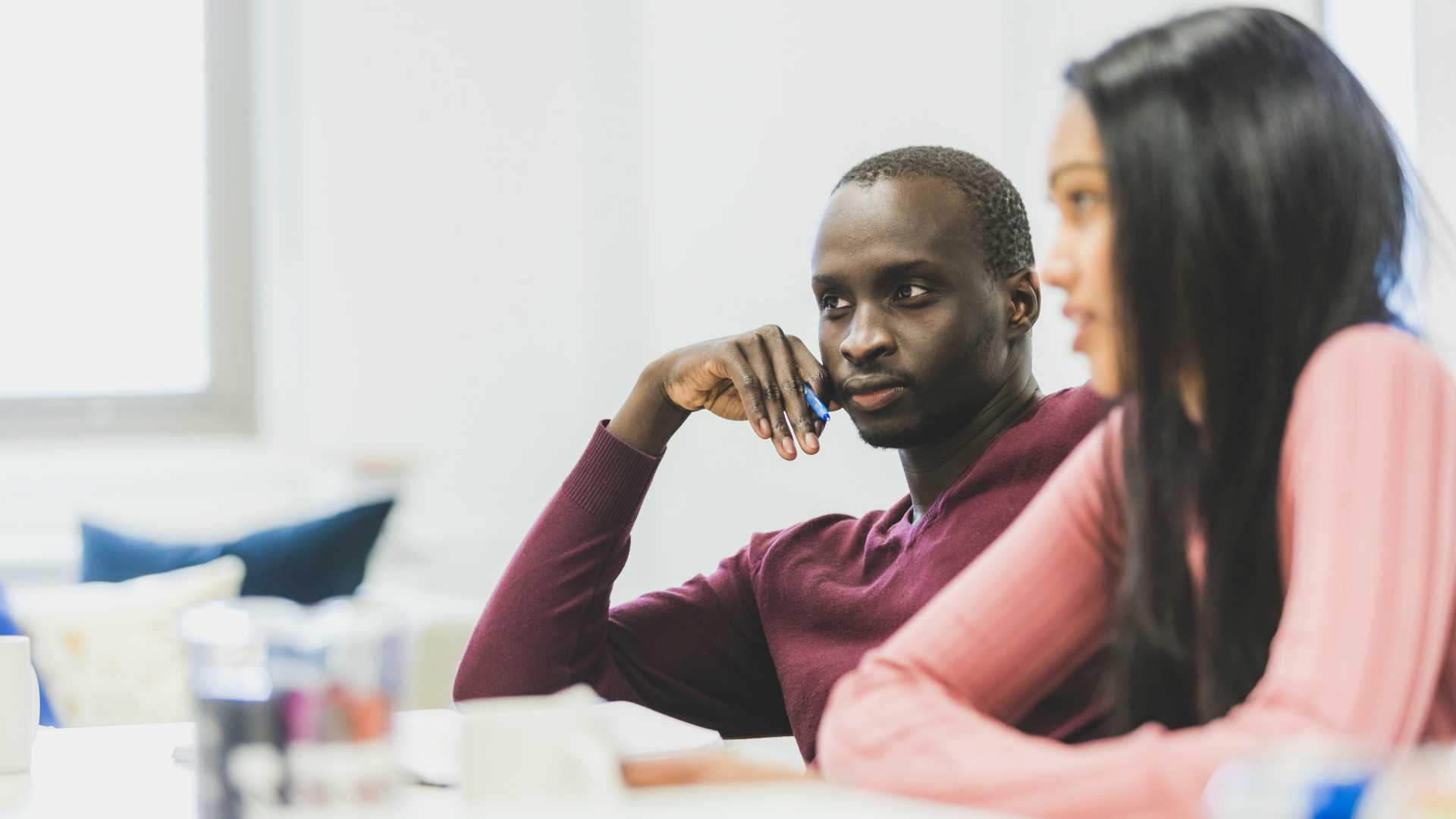 two people listening thoughtfully in a meeting