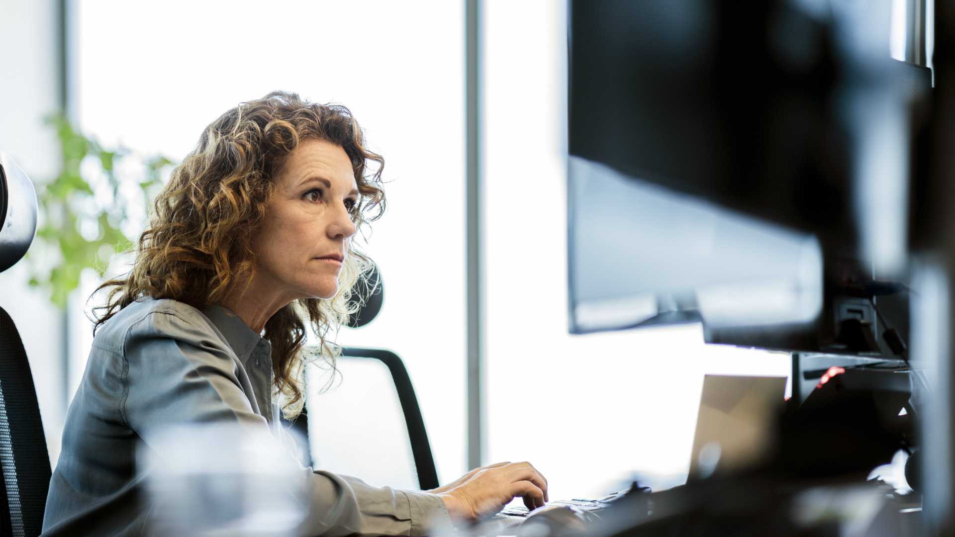 senior leader working on a computer, deep in thought
