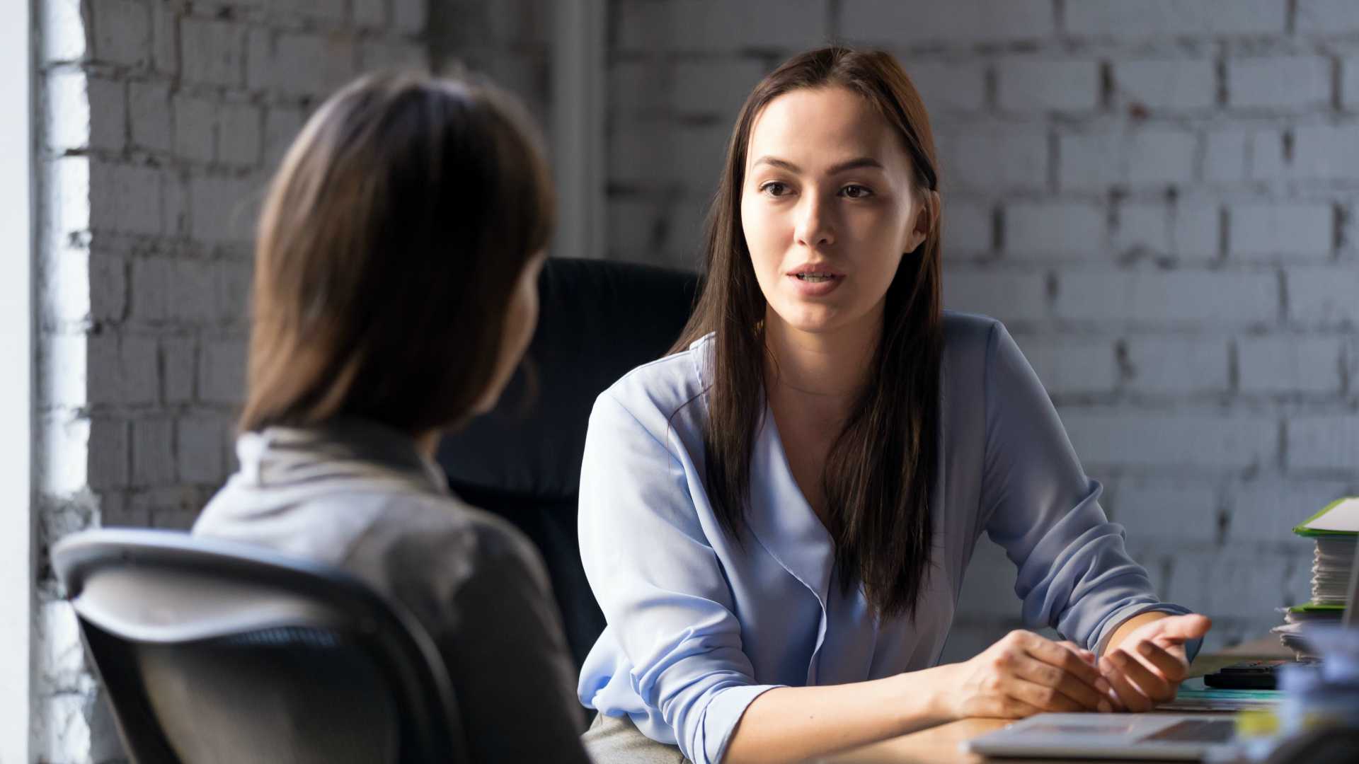 two women having a conversation at work