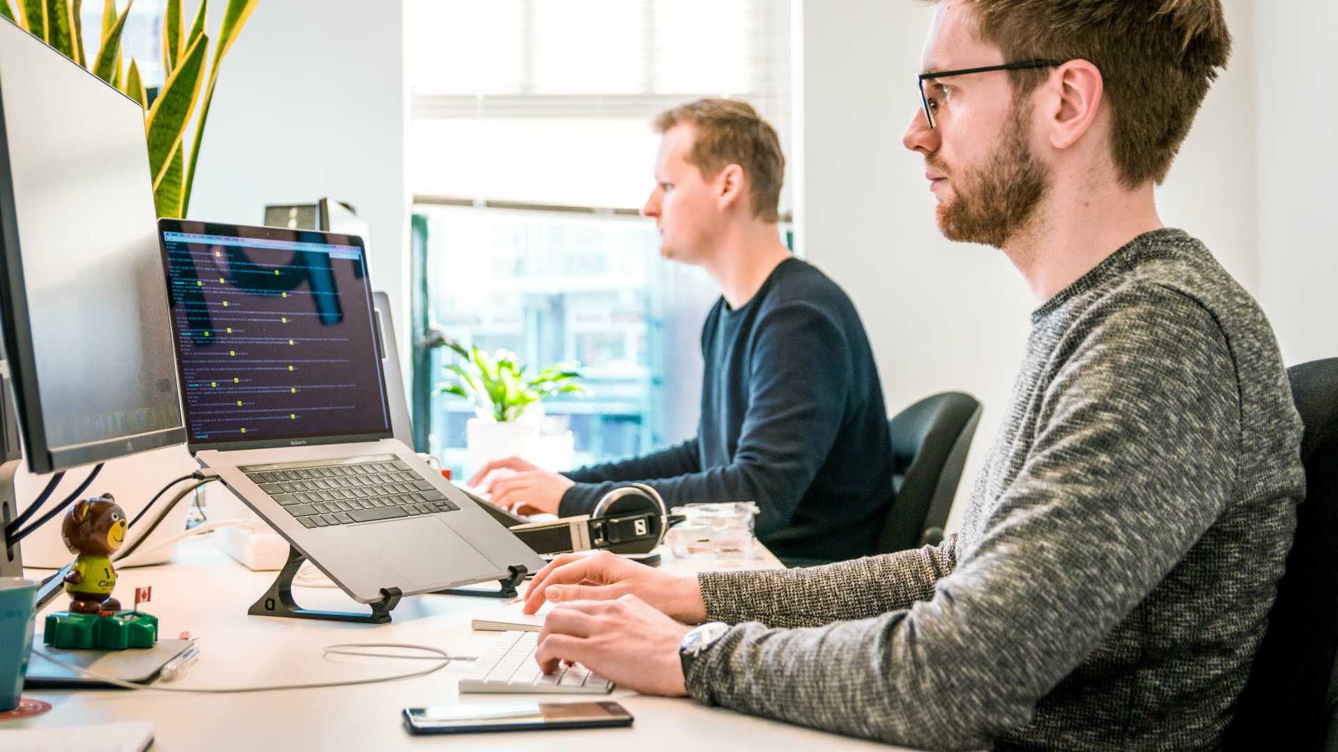 two programmers working in an open office