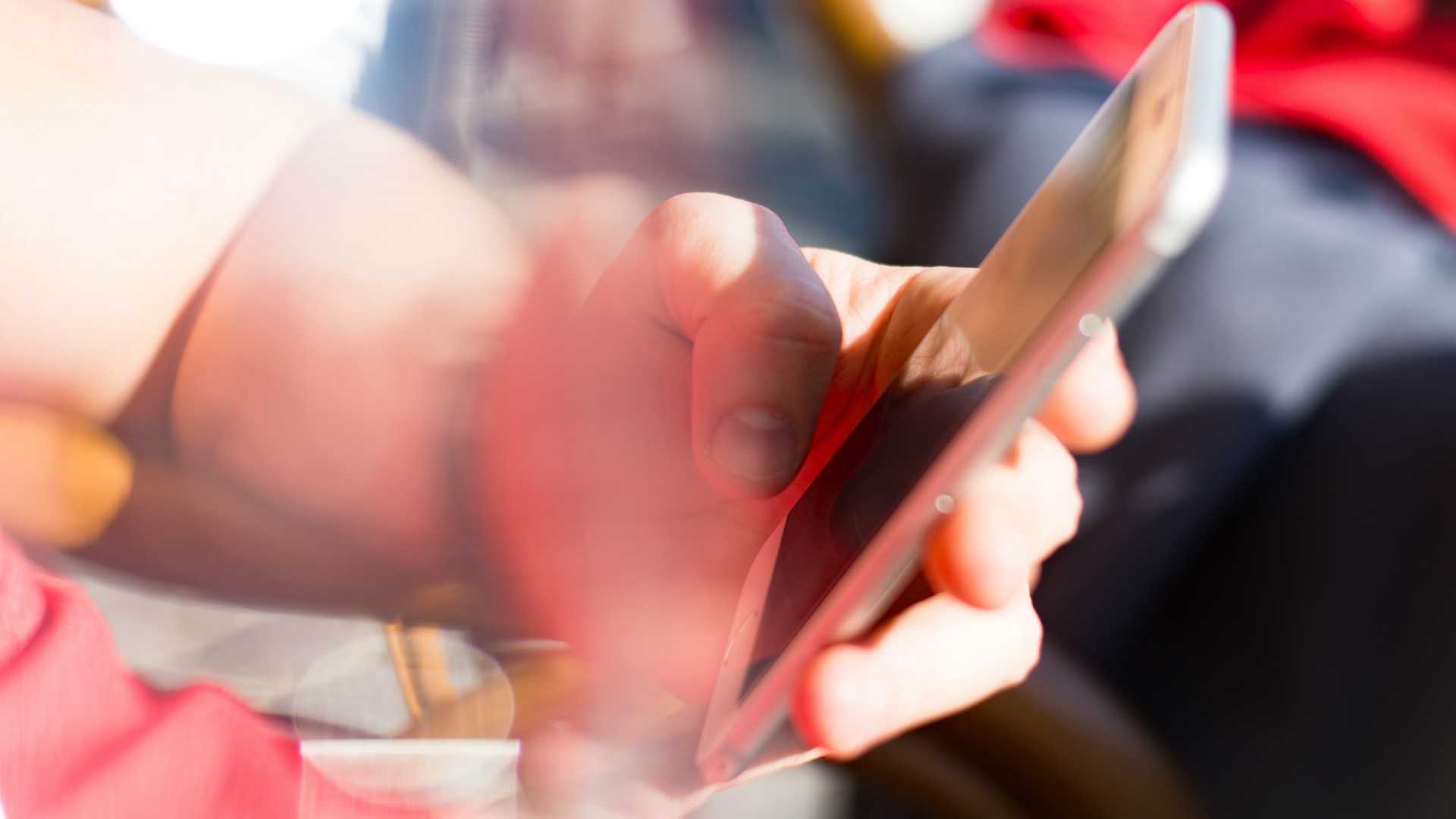 hand using a smartphone with a blurred background