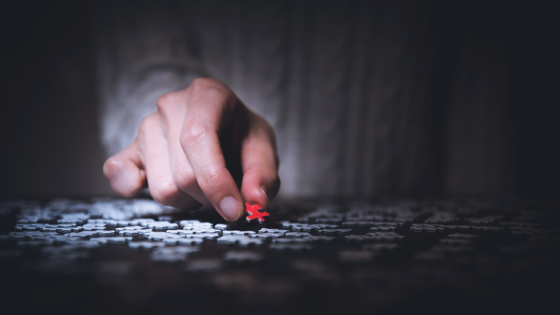 hand doing a puzzle