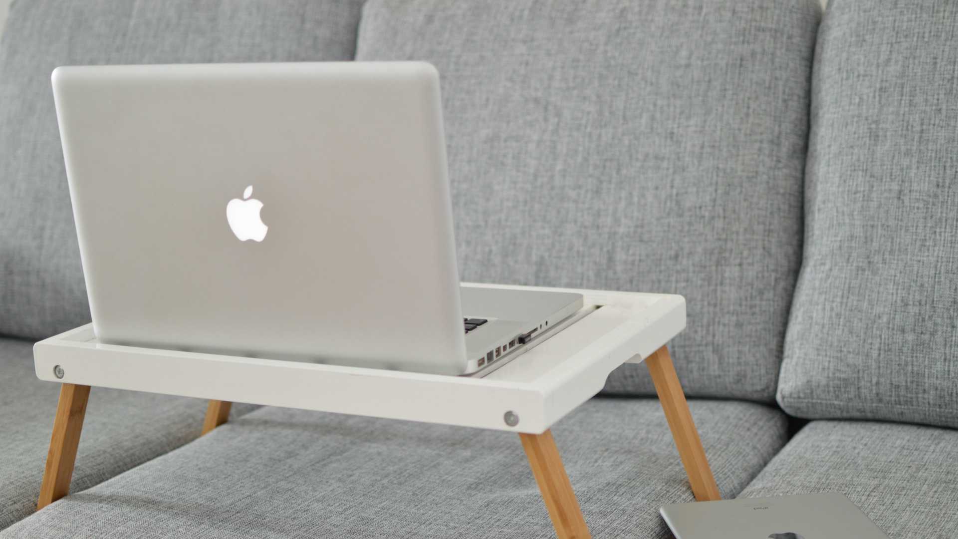 laptop on a laptop stand on a couch