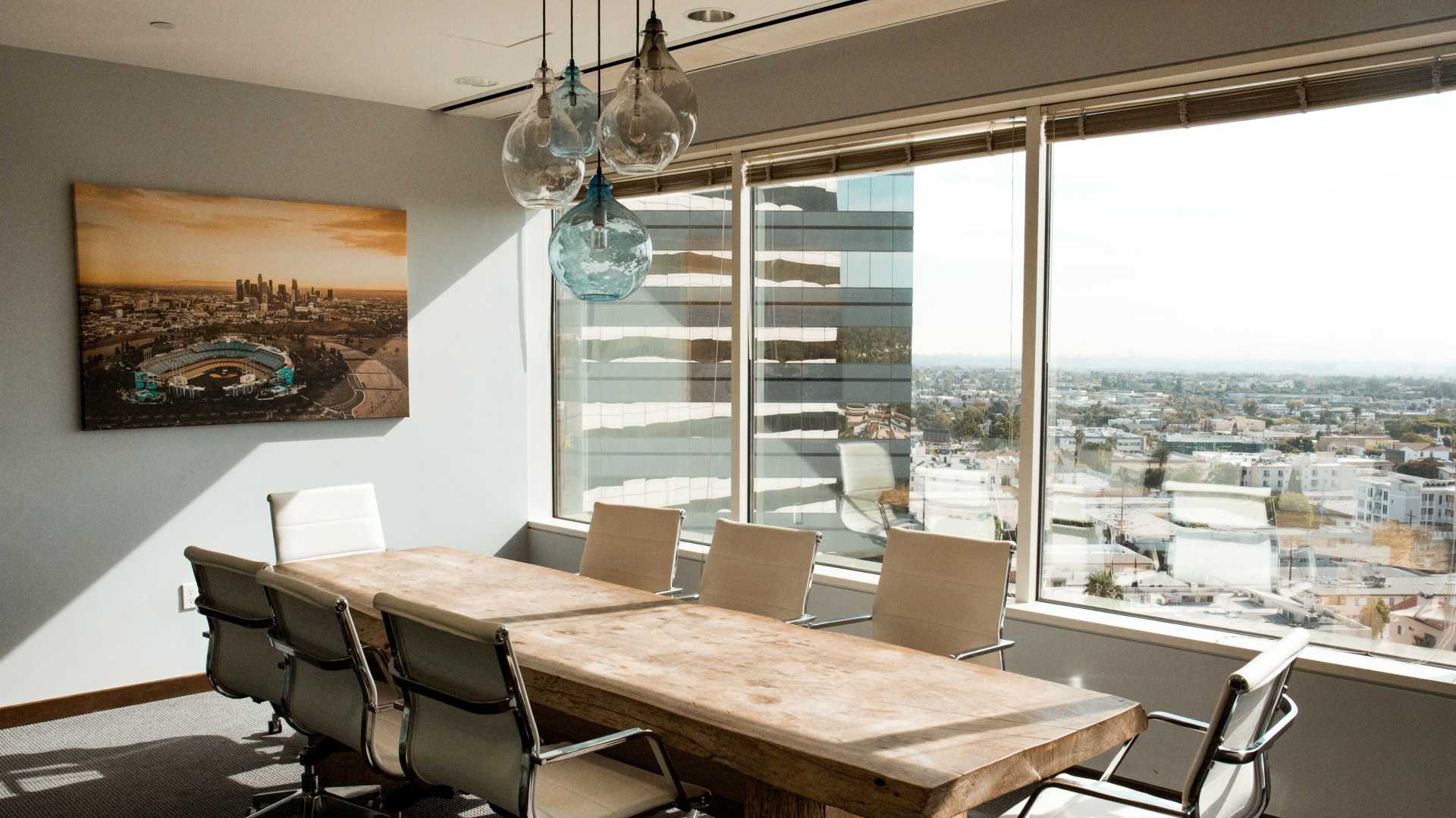 empty conference room with large windows overseeing a big city