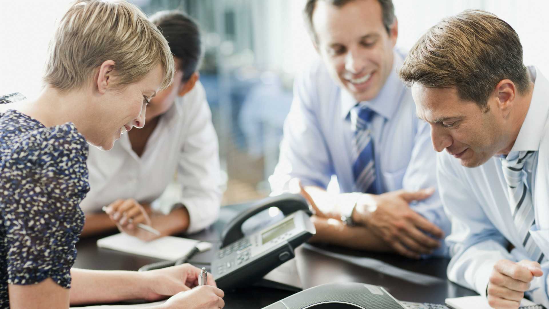 group of professionals on speaker phone